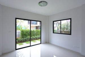 empty white clean room with glass door and window slide in new residential house